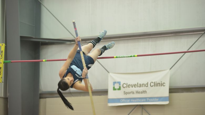 A Penn State Behrend student-athlete competes in the pole vault event.