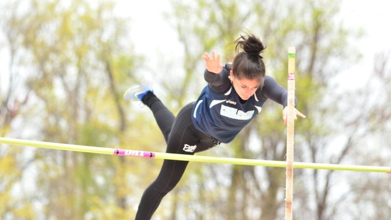 A Penn State Behrend student-athlete completes a pole vault jump.