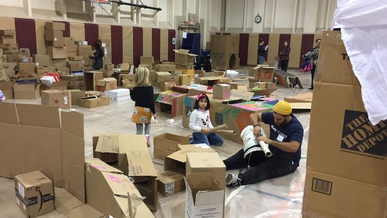 Photograph of gymnasium interior with cardboard boxes