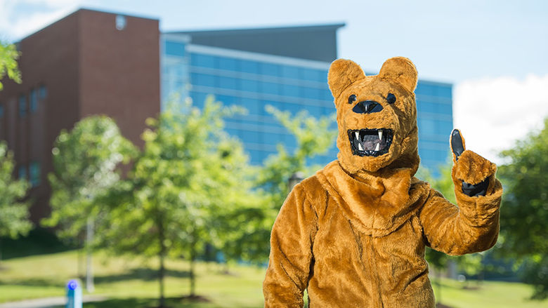 Nittany Lion standing in front of Burke Center