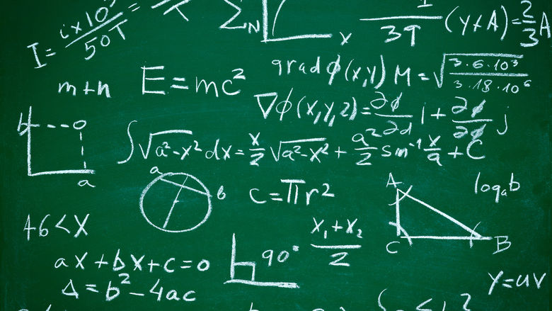 Math equations written on a blackboard.