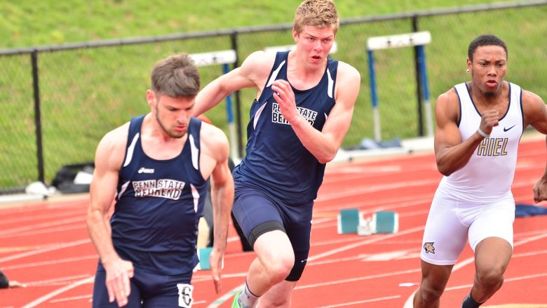 Two Penn State Behrend runners race on an outdoor track.