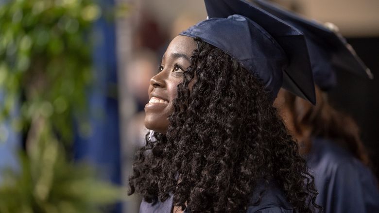 A student smiles during Penn State Behrend's spring commencement ceremony.