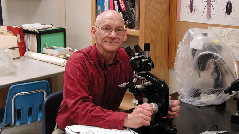 Penn State Behrend alumnus Peter Grant works at a microscope.