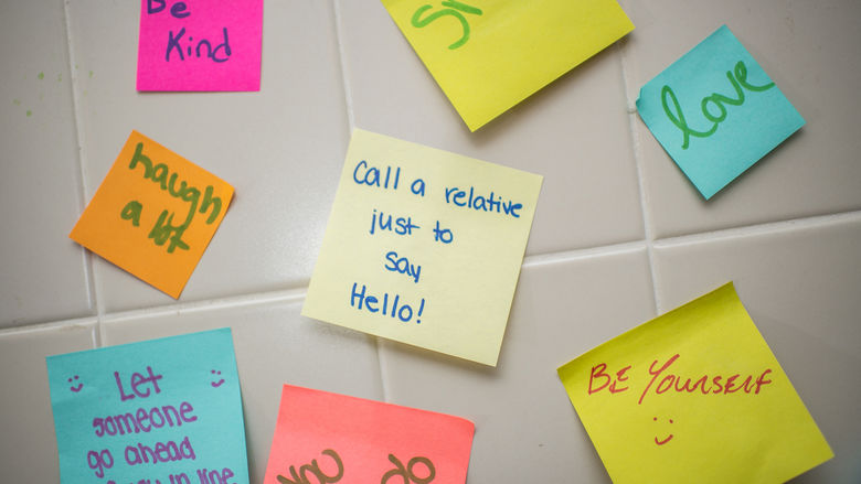 Close up of post-it notes with various messages written