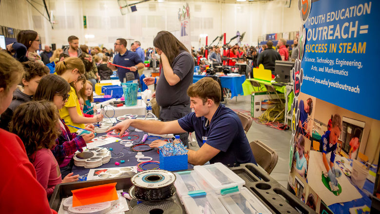 Children and parents look at exhibits at Penn State Behrend's sixth-annual STEAM fair