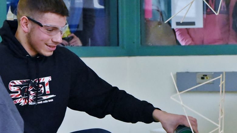 A student reacts as his balsa-wood bridge breaks during a Science Olympiad competition
