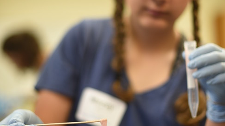 Macey Eyler observes the DNA that she had just isolated from strawberries and bananas during Math Options Career Day at Penn State Behrend on May 9.