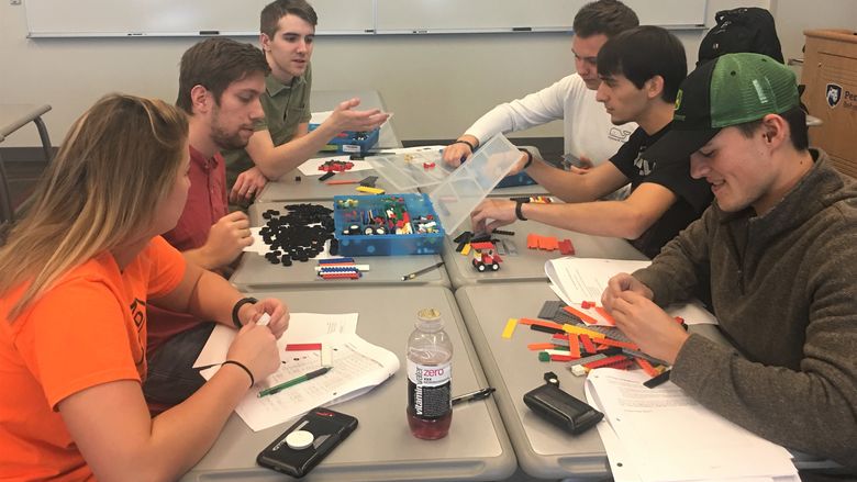 Students assemble Lego cars during a manufacturing simulation at Penn State Behrend.