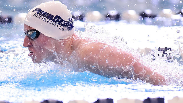 A Penn State Behrend swimmer competes in a race.