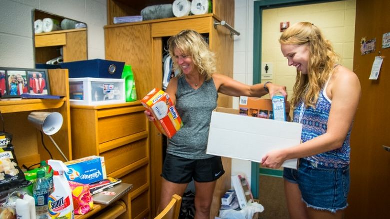 A student and her mother unpack at a Penn State Behrend residence hall.