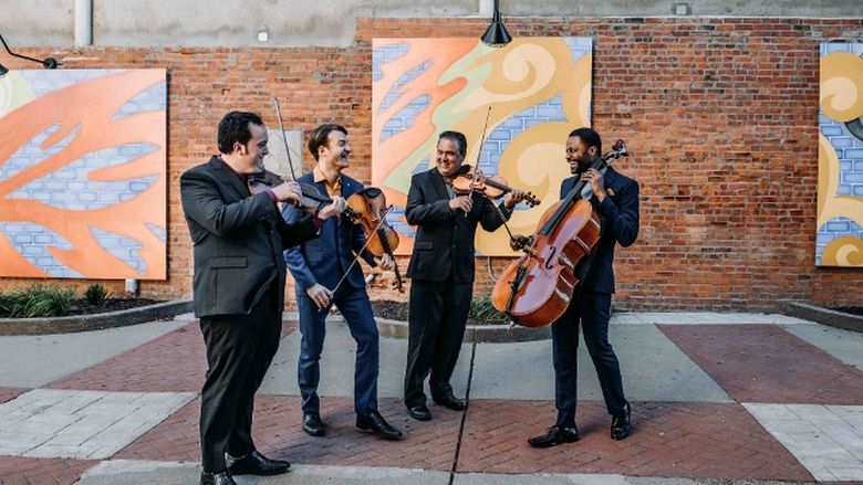 The Turtle Island Quartet performs in a street.
