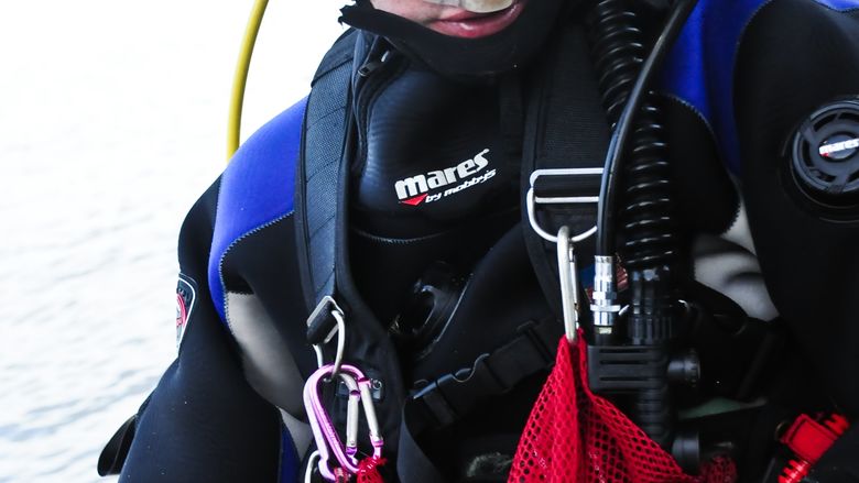 Scuba diver Bill Eberlein prepares to enter the water.