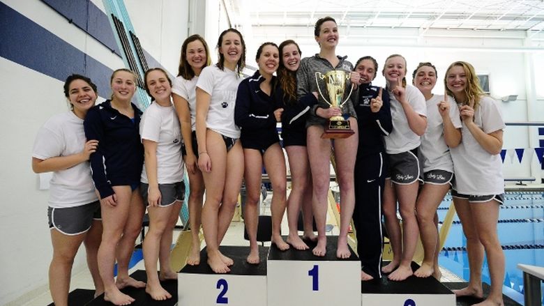 The Penn State Behrend women's swim team on the medals stand.