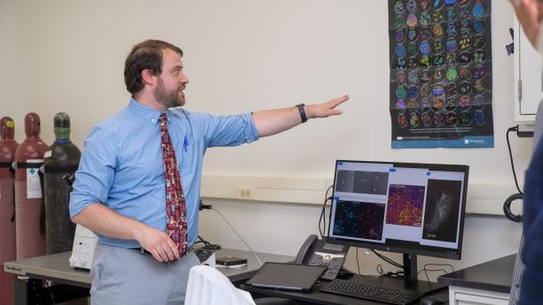 A Penn State Behrend faculty member leads a tour of the new biomedical translational research lab.