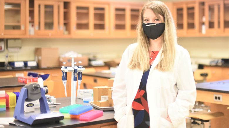 A portrait of Ashley Russell, assistant professor of biochemistry and molecular biology, in a lab at Penn State Behrend