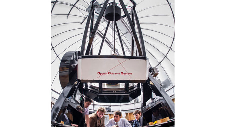 An astronomy team works with the iLocator, a spectrometer at the Large Binocular Telescope in Arizona.
