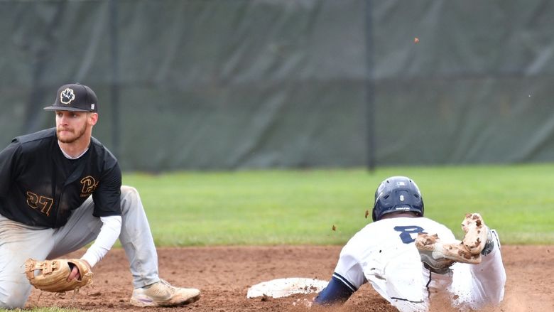 A Penn State Behrend baserunner slides toward a base.