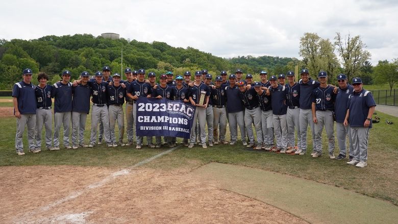 The Penn State Behrend baseball team poses with the ECAC championship banner.