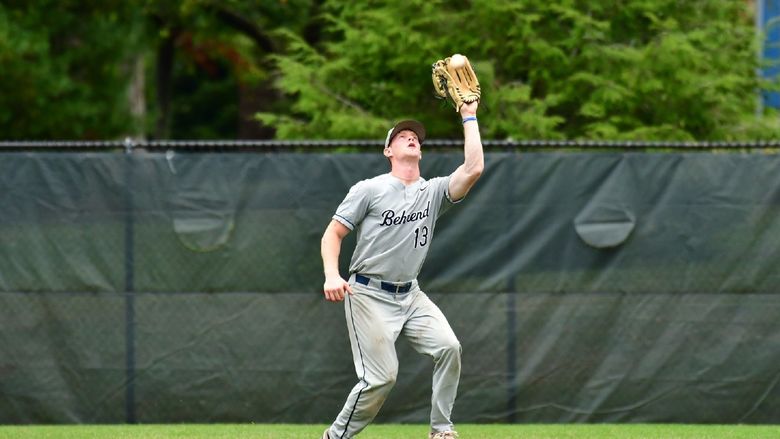 An outfielder catches the ball during a Penn State Behrend baseball game.