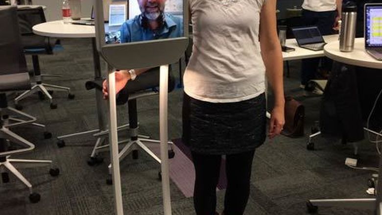 person standing next to beam robot