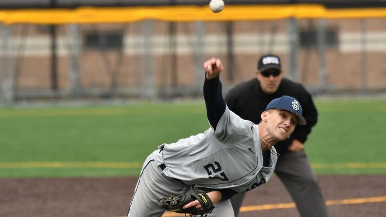 A pitcher for the Penn State Behrend baseball team throws the ball.