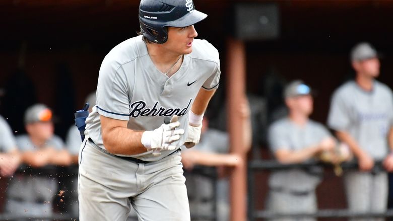 A Penn State Behrend baseball player runs to first base.