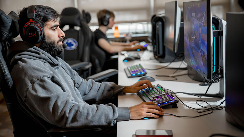 A Penn State Behrend student plays a video game in the college's new esports lounge.