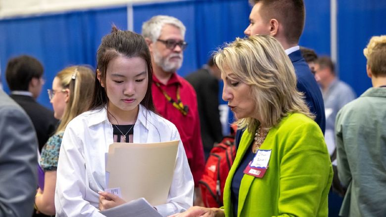 A Penn State Behrend student talks with a recruiter at the college's Career and Internship Fair.