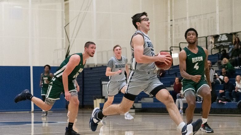 A Penn State Behrend basketball player prepares to take a layup.