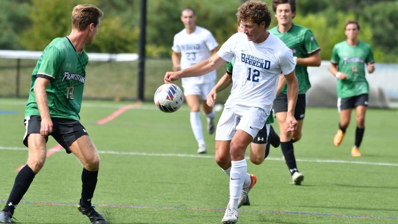 A member of the Penn State Behrend men's soccer team advances the ball during a game against Franciscan.