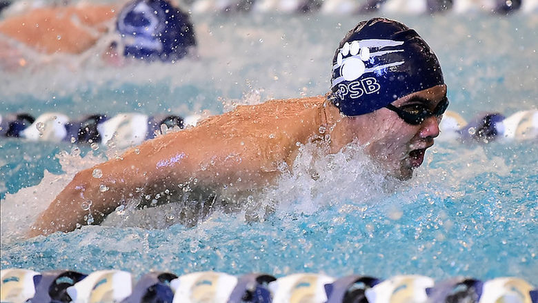 A Penn State Behrend swimmer competes in a butterfly event.