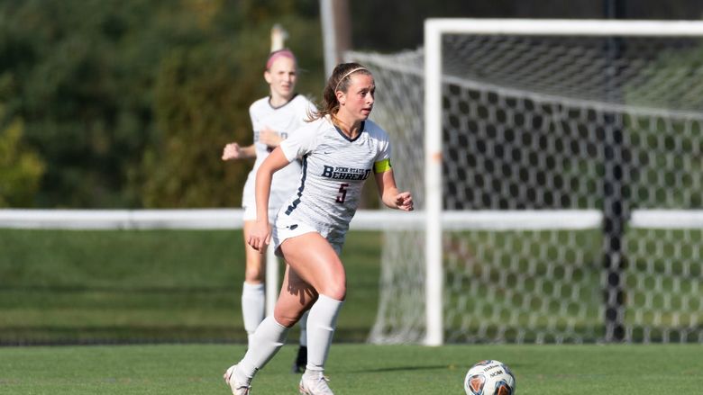 A Penn State Behrend soccer player prepares to kick the ball.