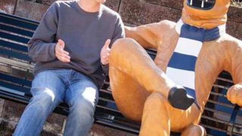 Behrend Magazine - Spring 2020 Cover: John Jarecki, Student Government Association president, sits on the Lion bench at Penn State Behrend.