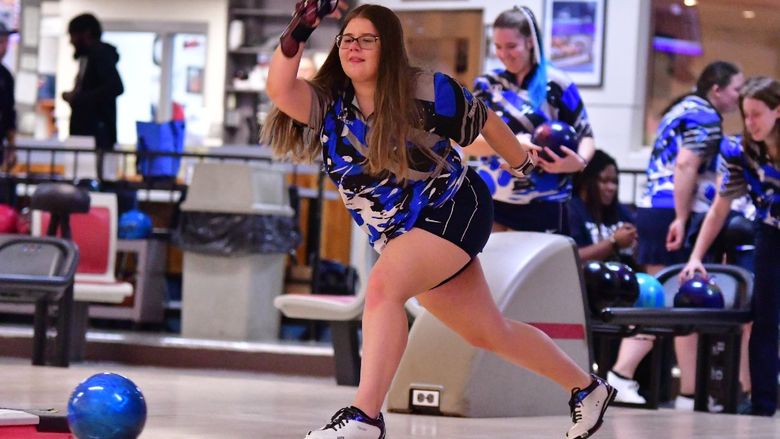 A member of the Penn State Behrend women's bowling team rolls the ball.