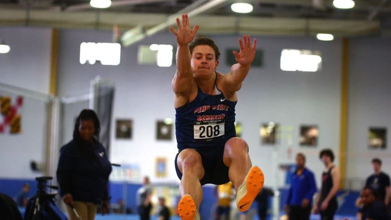 A Penn State Behrend track-and-field athlete competes in the long jump.