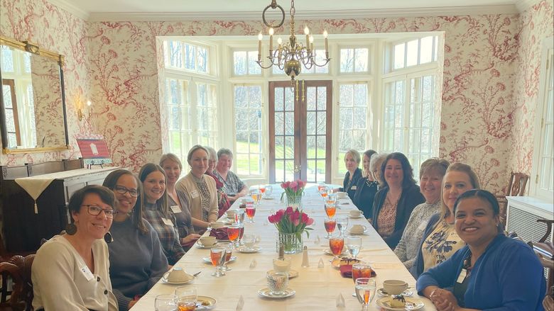 Group of women sitting at a table eating brunch