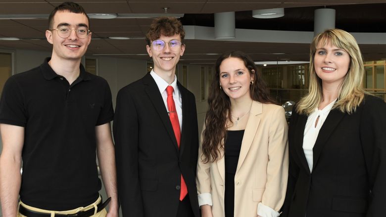 Four members of the Penn State Behrend CFA Institute Research Challenge team pose in Burke Center.