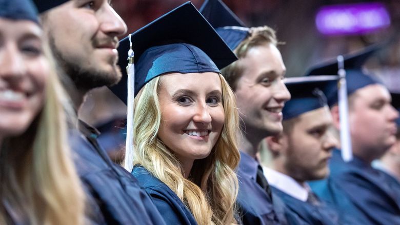 Graduates smile during a Penn State Behrend commencement program