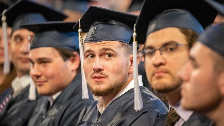 Students sit in a row during Penn State Behrend's spring commencement ceremony.