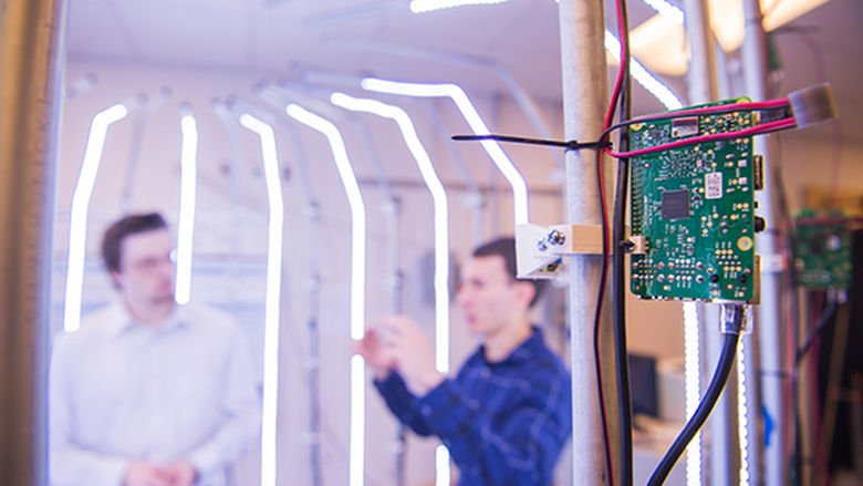 Two students demo 3D scanner that uses computer circuit boards
