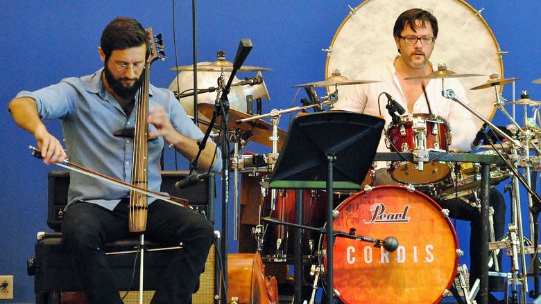 A cellist and drummer perform on state in McGarvey Commons at Penn State Behrend.