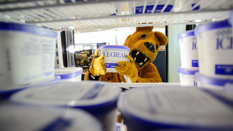 The Nittany Lion loads ice cream into a freezer