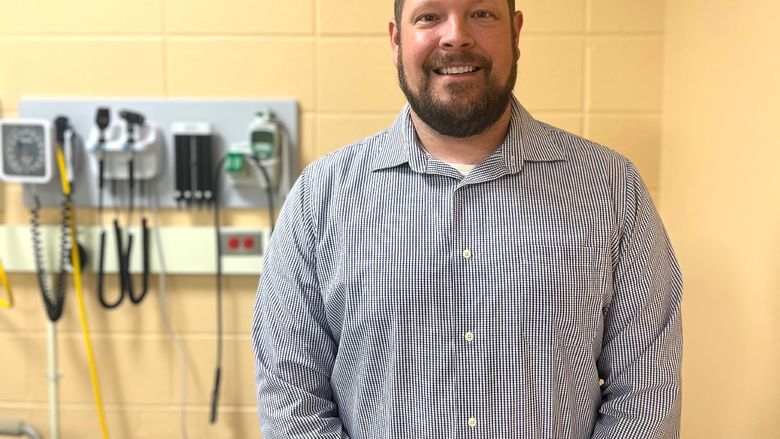 Daniel Eaton, a nursing instructor at Penn State Behrend, poses in a simulation lab.