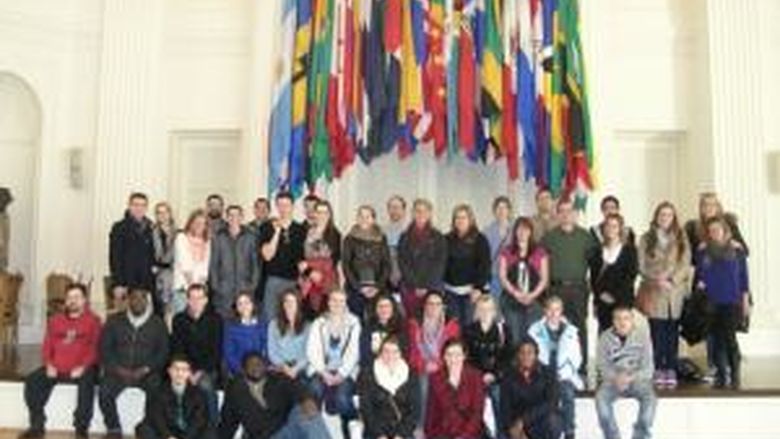 Students stand under flags at OAS HQ
