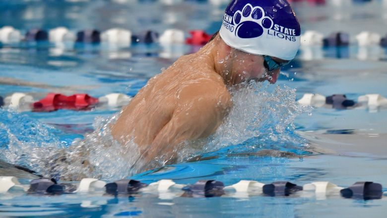 A Penn State Behrend swimmer competes in a breaststroke race.
