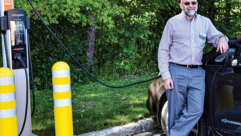 Dr. Michael Rutter, associate director of the School of Science, charges his electric vehicle at a charging station near the Science Complex.