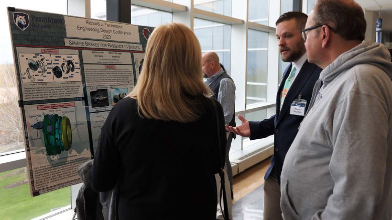 A student explains his capstone engineering project to visitors at Penn State Behrend's Fasenmyer Engineering Design Conference.