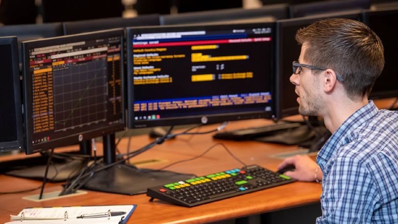 A student in Penn State Behrend's Black School of Business tracks a stock's performance on a Bloomberg Terminal.