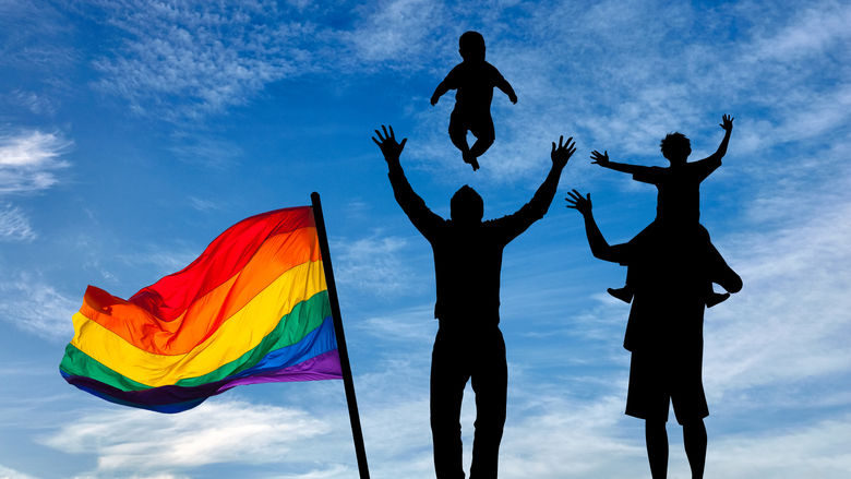 Image of gay fathers with child.